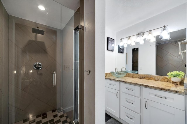 bathroom with vanity and a shower with door