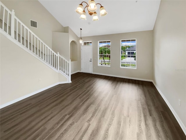 interior space featuring a chandelier, vaulted ceiling, and dark hardwood / wood-style floors