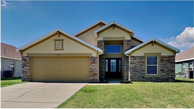 view of front of home featuring central air condition unit, a front lawn, and a garage