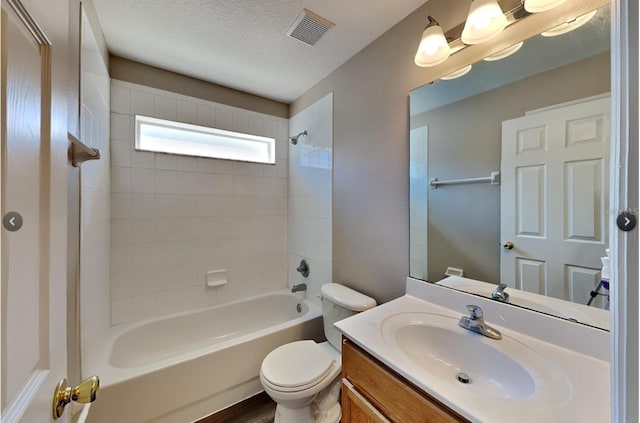 full bathroom with a textured ceiling, toilet, tiled shower / bath, vanity, and hardwood / wood-style flooring