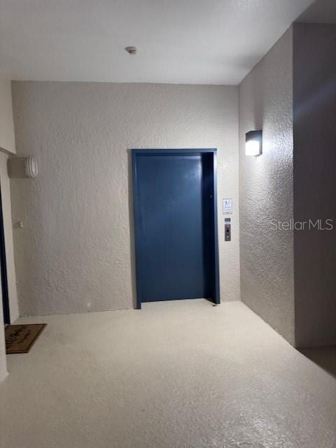 unfurnished room with elevator