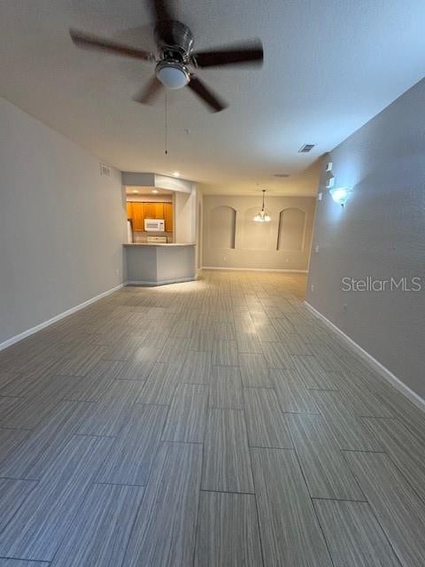 unfurnished living room with ceiling fan