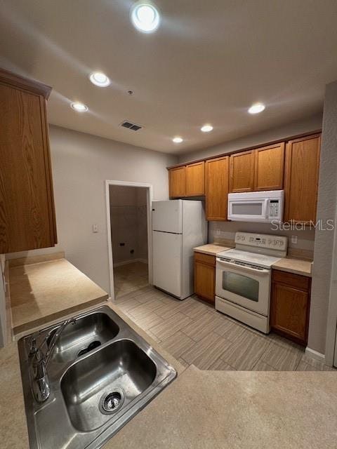 kitchen with sink and white appliances