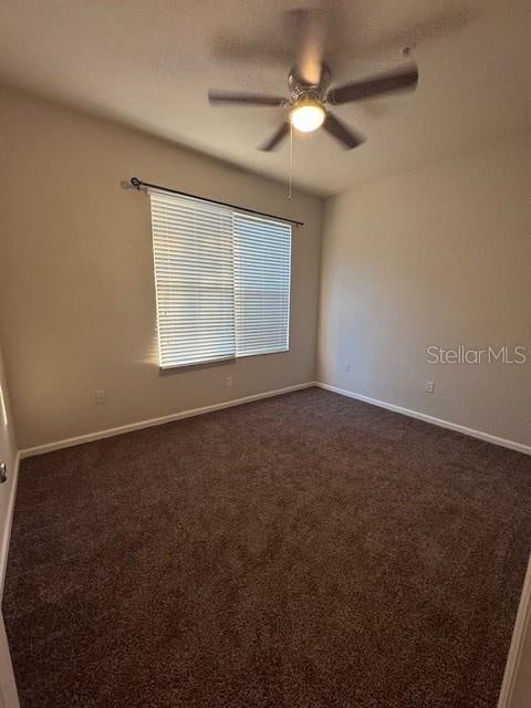 carpeted empty room with ceiling fan