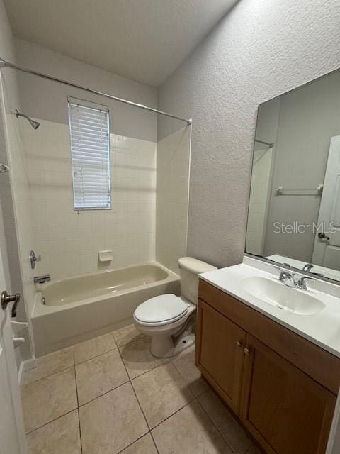 full bathroom with vanity, tiled shower / bath, toilet, and tile patterned floors