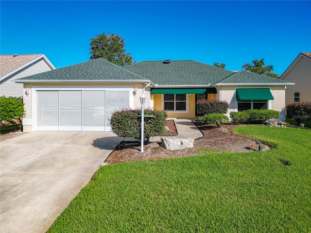 single story home with a front yard and a garage