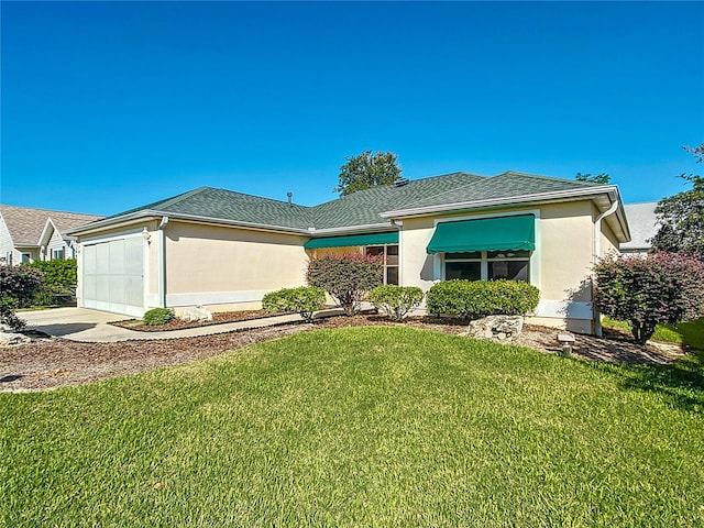 view of front of house with a front lawn and a garage