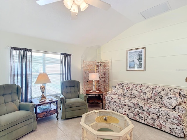 living room featuring ceiling fan, light tile patterned floors, and vaulted ceiling