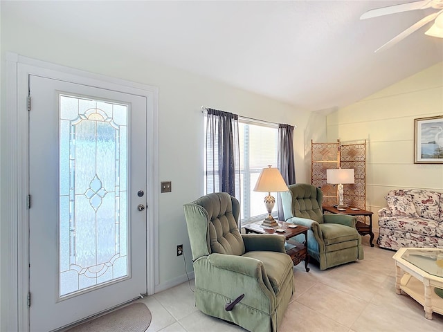 foyer entrance featuring lofted ceiling, ceiling fan, and light tile patterned floors