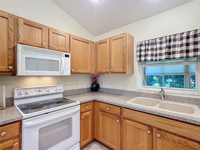 kitchen featuring sink, vaulted ceiling, and white appliances