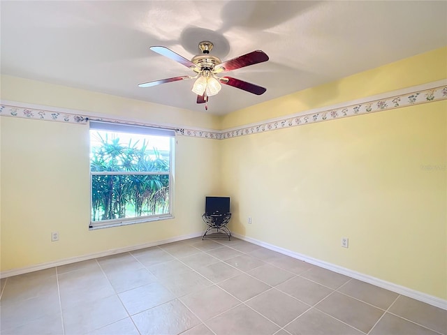 spare room with light tile patterned floors and ceiling fan