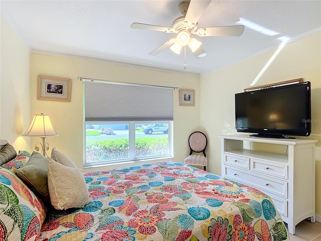 bedroom with ornamental molding and ceiling fan