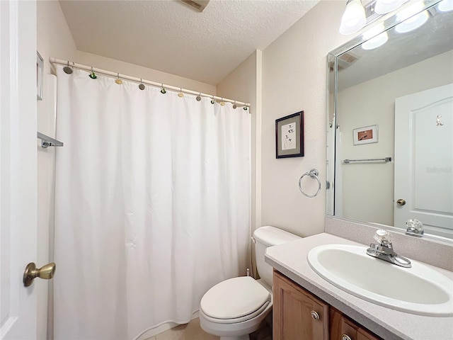 bathroom featuring vanity, a shower with shower curtain, a textured ceiling, and toilet