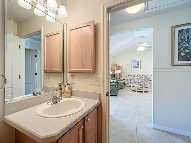 bathroom with vanity, lofted ceiling, ceiling fan, and tile patterned flooring