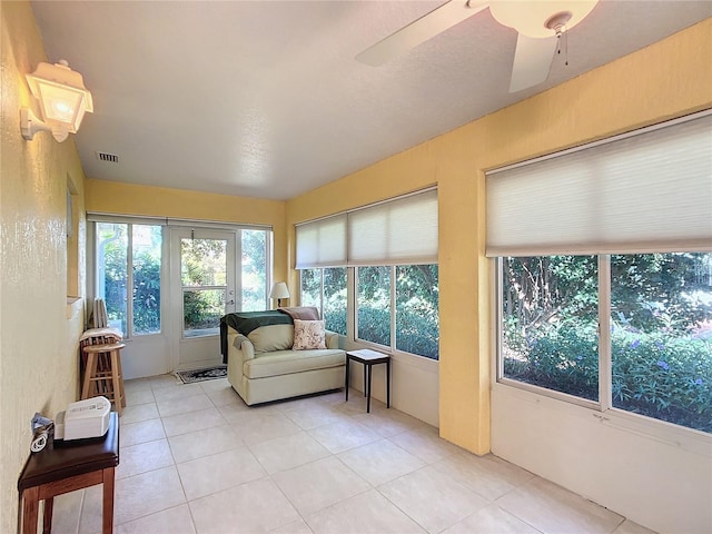 sunroom / solarium featuring ceiling fan