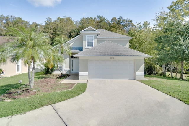 view of front of home with a front yard and a garage