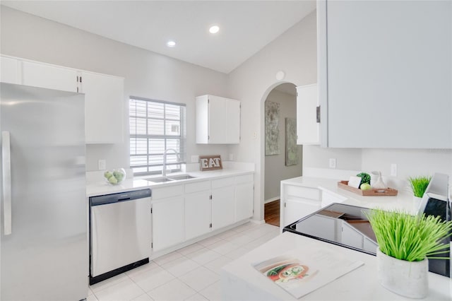 kitchen with sink, white cabinets, stainless steel appliances, and light tile patterned flooring