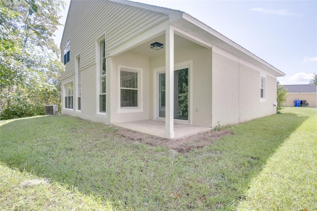 back of house with a patio, a lawn, and cooling unit