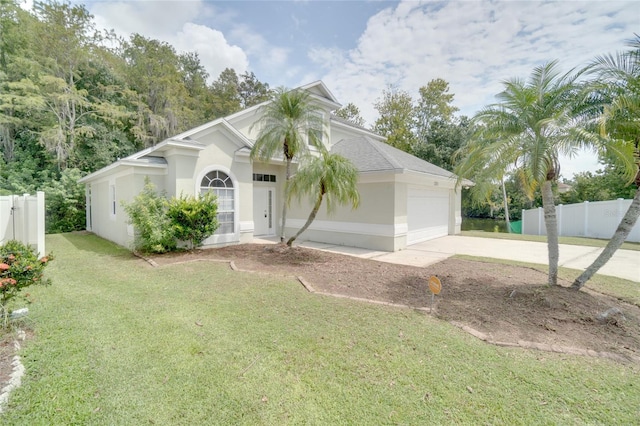 view of front of house with a front yard and a garage