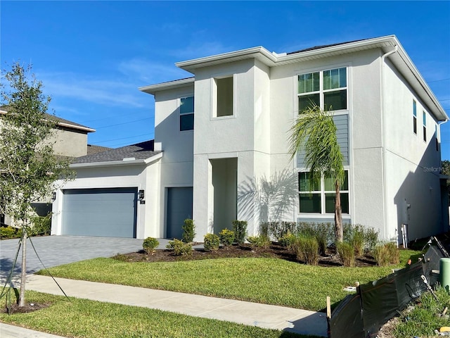 58 Overleaf Ln, Orlando, FL 32839 - view of front facade with stucco siding, a front lawn, an attached garage, and decorative driveway