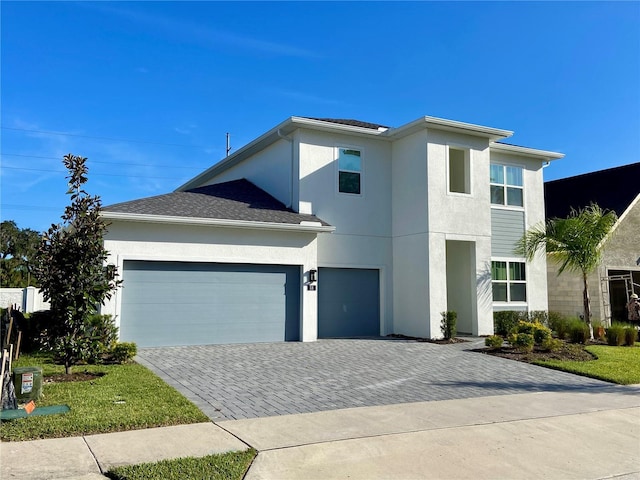 58 Overleaf Ln, Orlando, FL 32839 - view of front of house with stucco siding, decorative driveway, and a garage