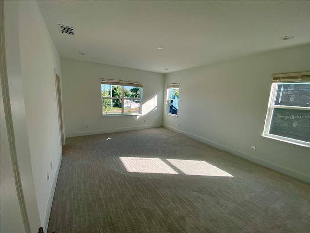 empty room featuring dark carpet