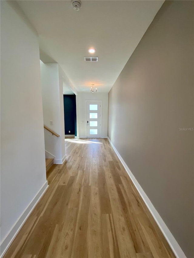 corridor with light hardwood / wood-style flooring