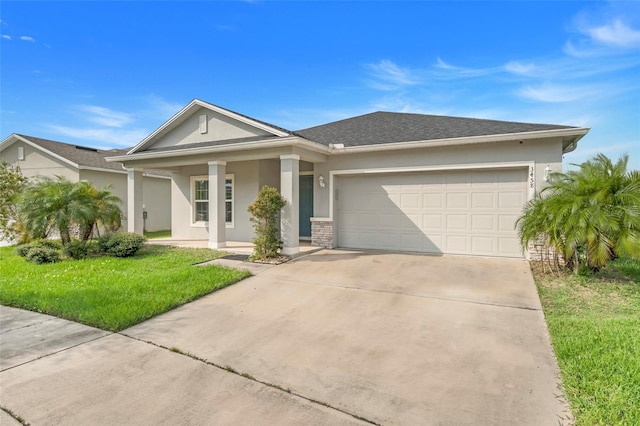 ranch-style house featuring a front yard and a garage