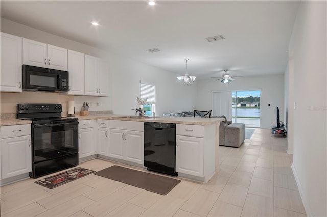 kitchen with white cabinetry, black appliances, and kitchen peninsula