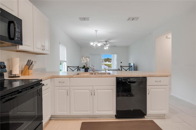 kitchen with kitchen peninsula, an inviting chandelier, white cabinetry, black appliances, and sink