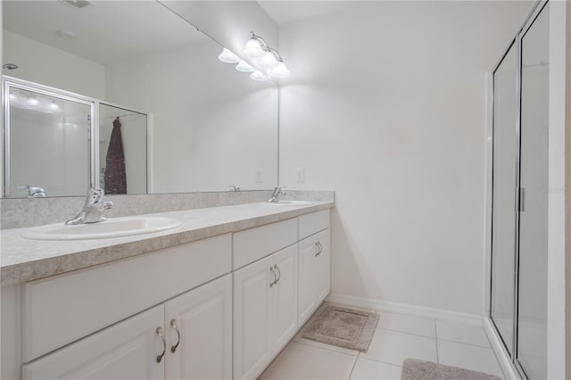 bathroom featuring vanity, a shower with shower door, and tile patterned flooring