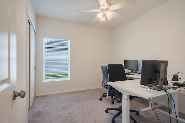 office space featuring light carpet and ceiling fan