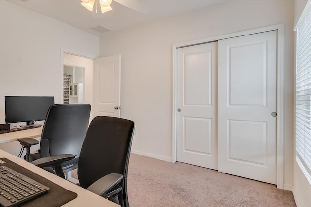 carpeted office space featuring ceiling fan