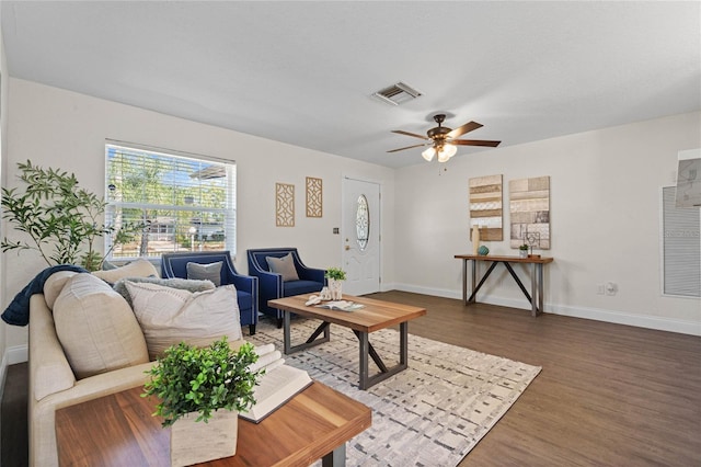 living room featuring ceiling fan and dark hardwood / wood-style flooring