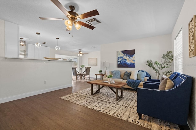 living room featuring ceiling fan and hardwood / wood-style flooring