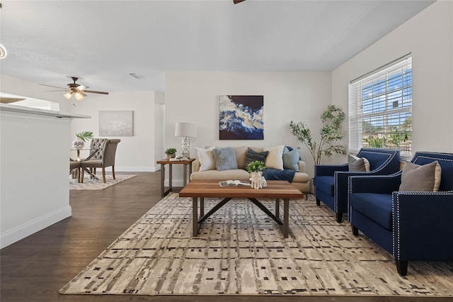 living room featuring wood-type flooring and ceiling fan