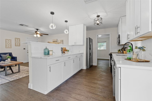 kitchen featuring sink, white cabinets, stainless steel appliances, and dark hardwood / wood-style flooring