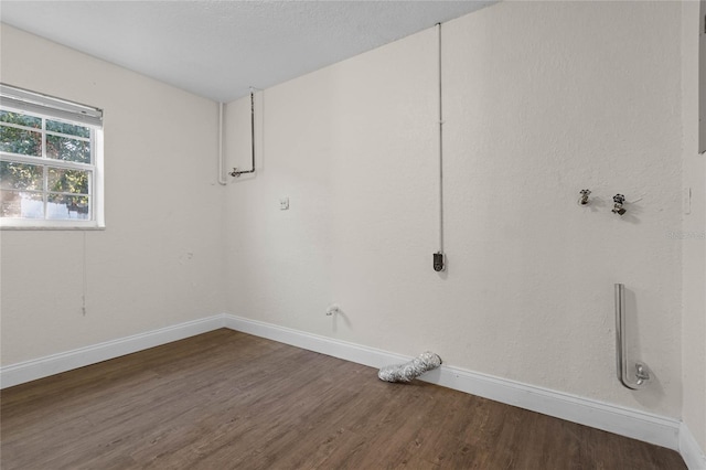 interior space with a textured ceiling, dark wood-type flooring, and electric dryer hookup