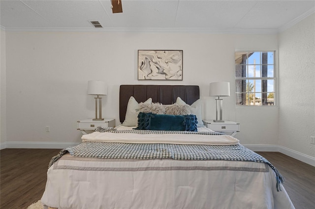 bedroom featuring dark wood-type flooring, ceiling fan, and crown molding