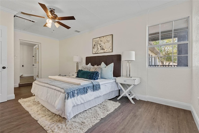 bedroom with ornamental molding, dark hardwood / wood-style floors, and ceiling fan