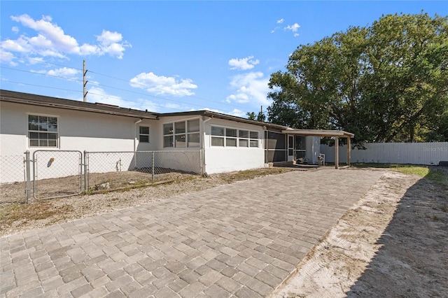 view of front facade with a patio area and a sunroom