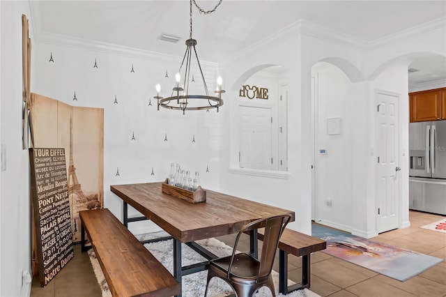 tiled dining space with ornamental molding and a chandelier