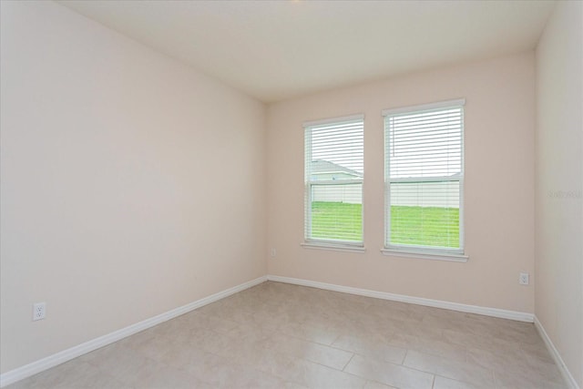 spare room featuring light tile patterned floors