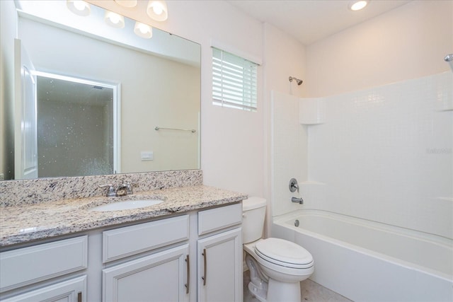 full bathroom featuring vanity, bathtub / shower combination, and toilet