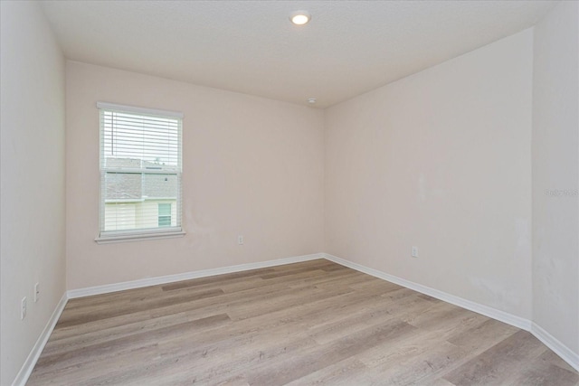 spare room featuring light wood-type flooring