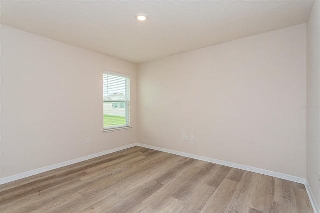 unfurnished room featuring light hardwood / wood-style floors