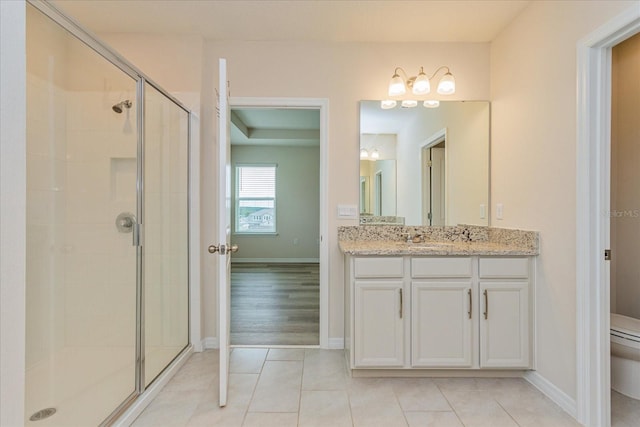 bathroom with vanity, toilet, hardwood / wood-style flooring, and a shower with door