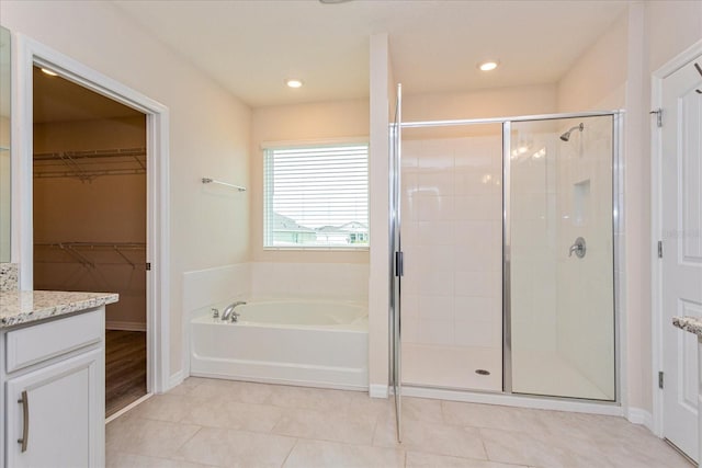 bathroom with vanity, plus walk in shower, and tile patterned floors