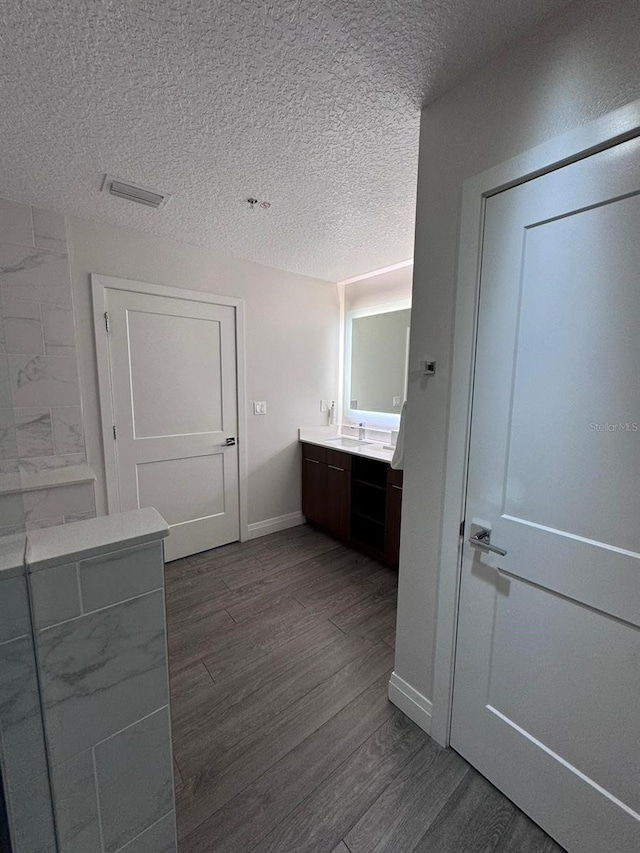 bathroom featuring vanity, a textured ceiling, and wood-type flooring