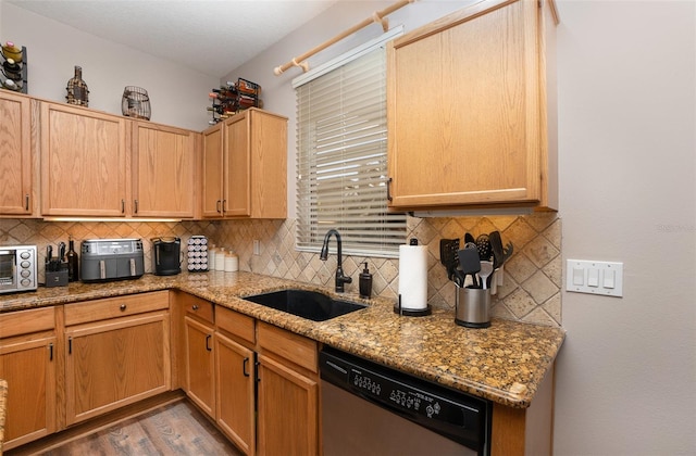 kitchen with dishwasher, sink, decorative backsplash, light stone countertops, and dark hardwood / wood-style flooring